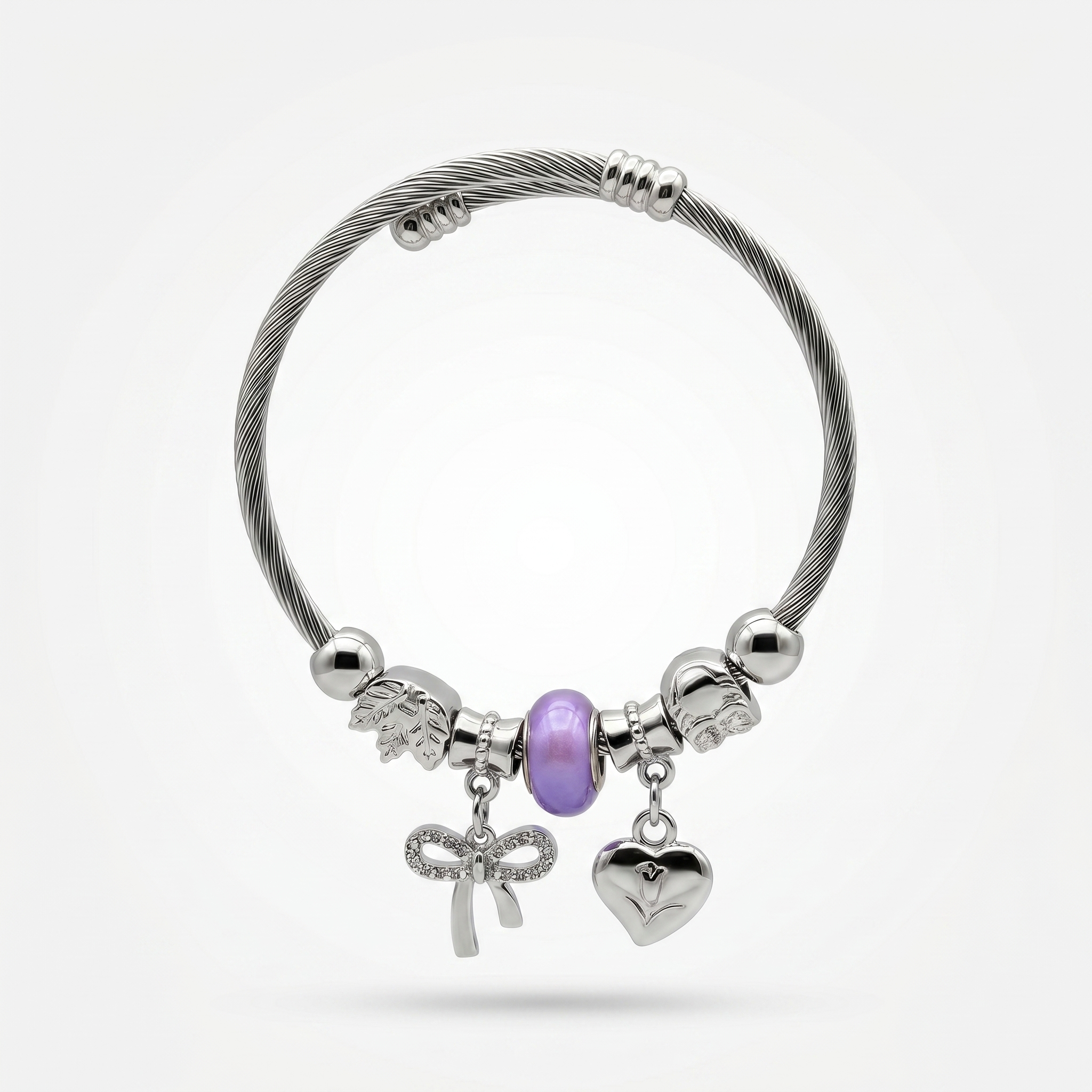 Silver bracelet with various charms on a white background