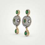 Pair of earrings with green gemstones and gold accents on a white background
