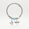 Silver bracelet with butterfly, dragonfly, and round charm on a white background